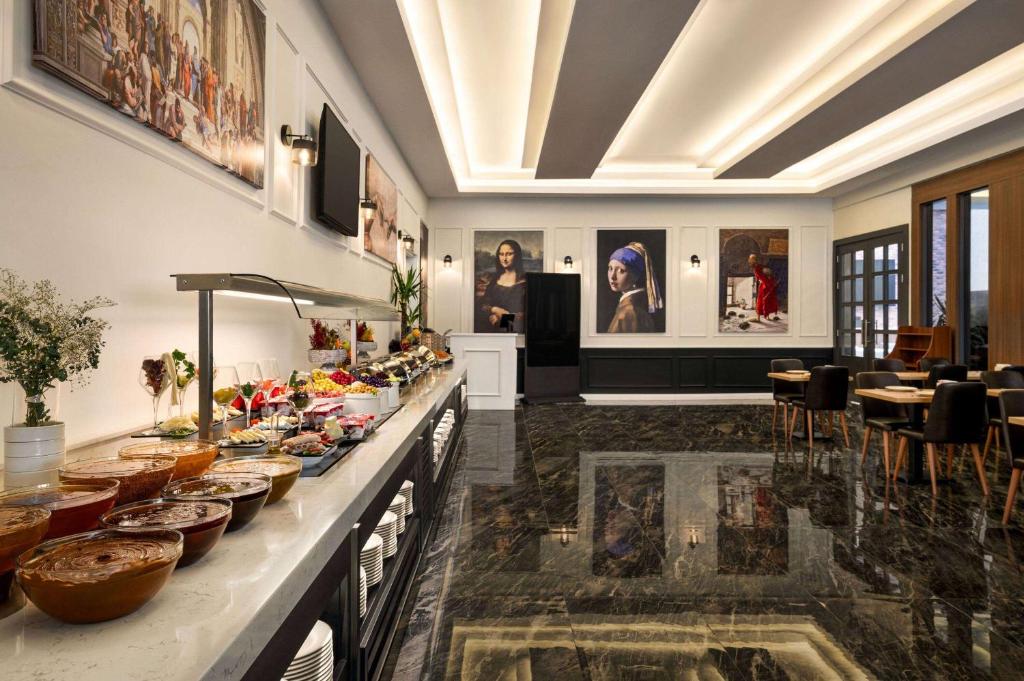 a room with a buffet of food on a counter at Ramada by Wyndham Karacabey in Bursa