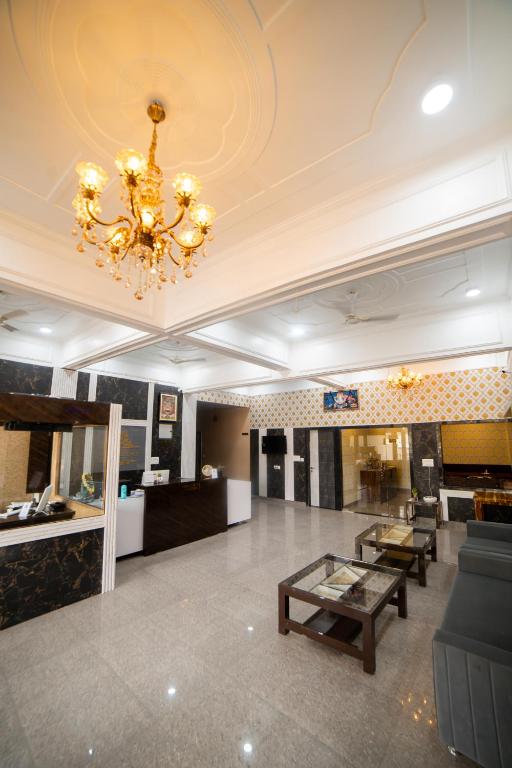 a large lobby with a chandelier and a table at HOTEL METRO REGENCY INN in Jaipur