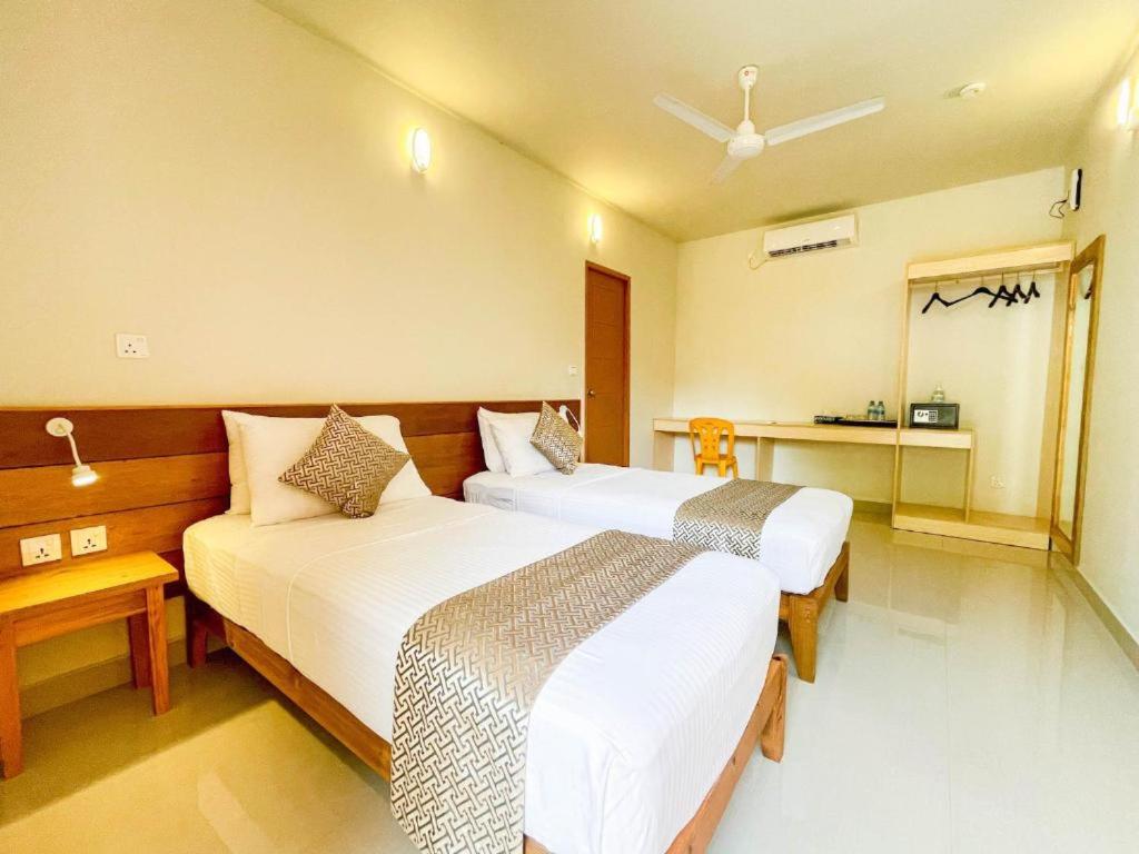 a hotel room with two beds in a room at SUFFIX RETREAT in Fuvahmulah