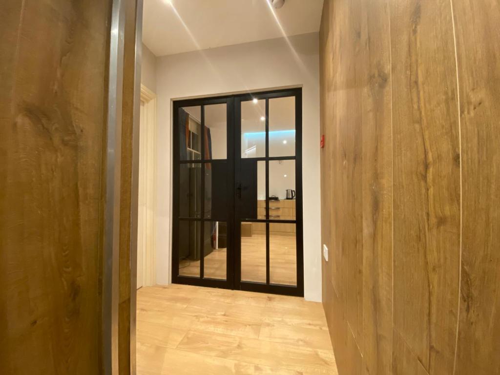 a hallway with a glass door in a room at Tiny but private & best Location in London