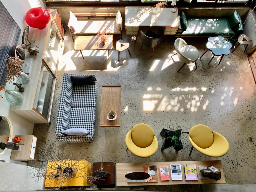 an overhead view of a living room with yellow chairs at Kaia Gallery Hotel Hoi An in Hoi An