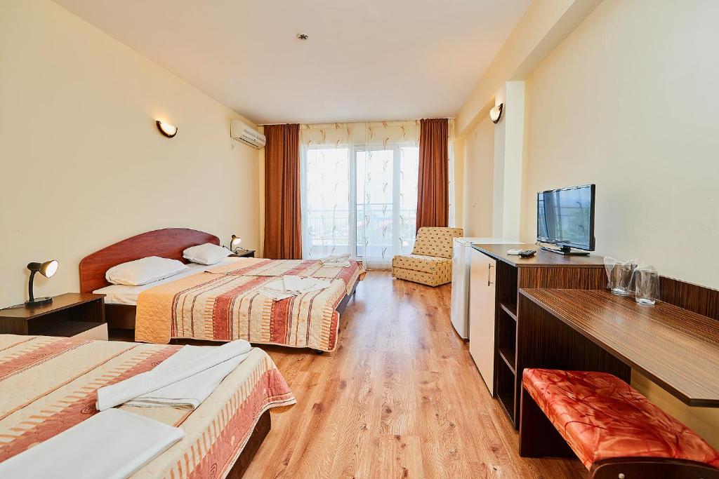 A bed or beds in a room at Complex Relax Pomorie All Inclusive