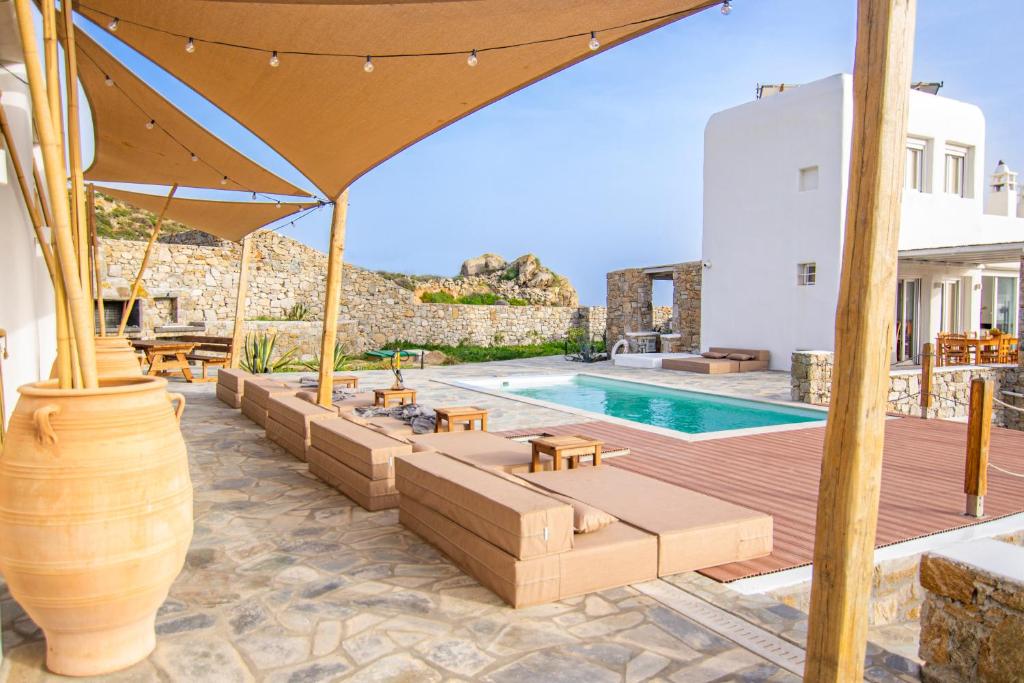 a villa with a swimming pool and a patio at Villa Poppy private pool by opus in Mikonos