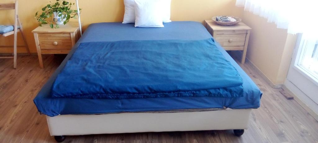 a bed with a blue comforter on it in a bedroom at Buda Super Panorama in Budapest