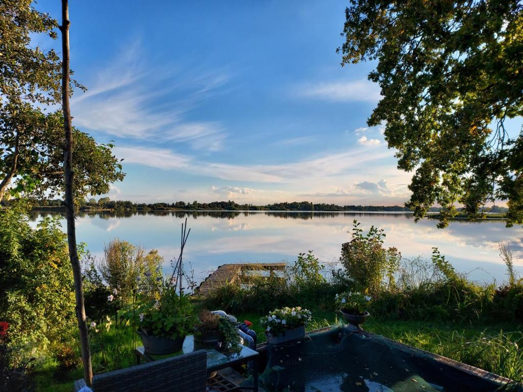 a view of a lake from the backyard of a house at Exceptional house on the waterfront in Reeuwijk