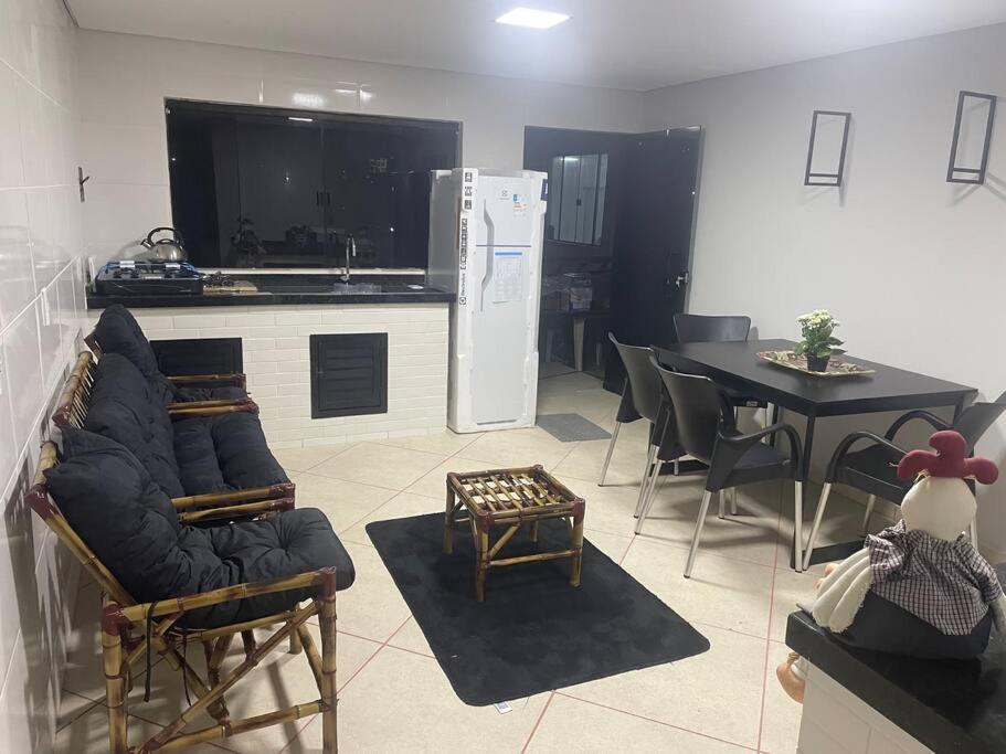 a living room with a couch and a table and a kitchen at Sol-v-mar in Penha