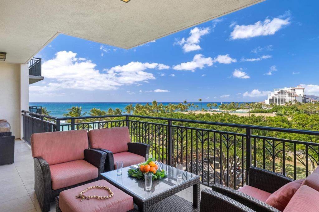 a balcony with chairs and a table with a view of the ocean at Ko Olina Beach Villas B602 in Kapolei