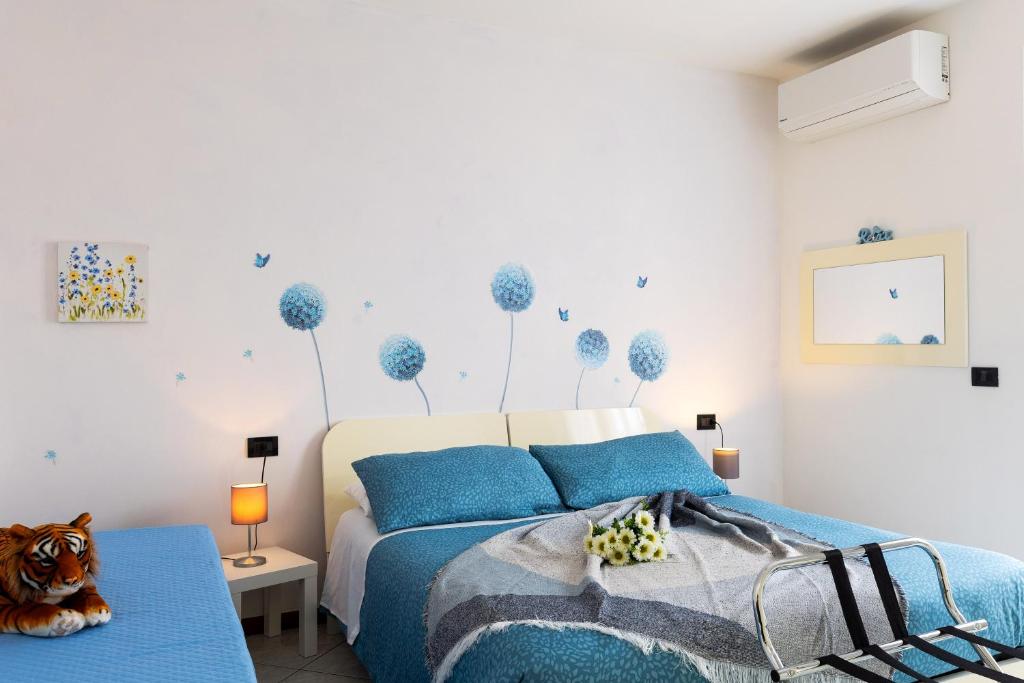 a bedroom with a bed with blue pillows at SORRIDI AL LAGO in Sirmione