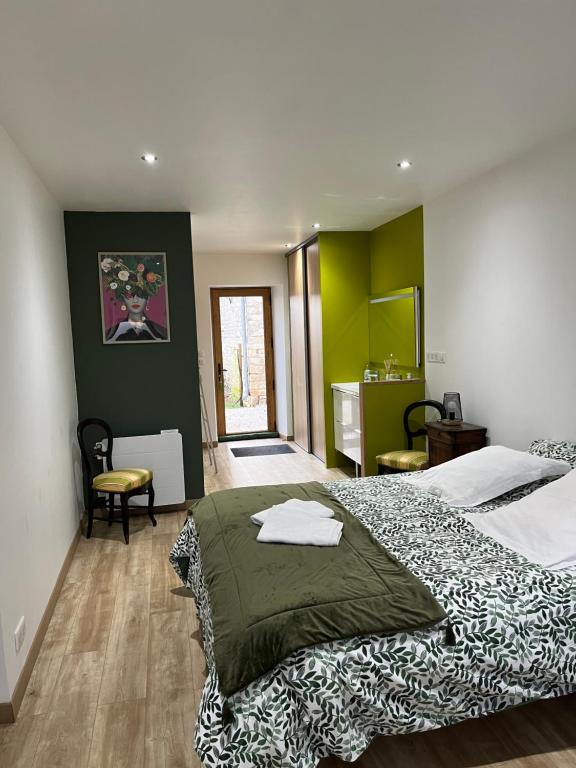 a bedroom with a large bed in a room at CERES HOME in Montierchaume