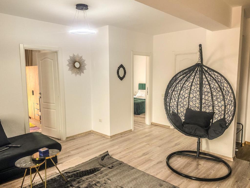 a living room with a swing chair and a couch at Luxury Bucovina in Gura Humorului