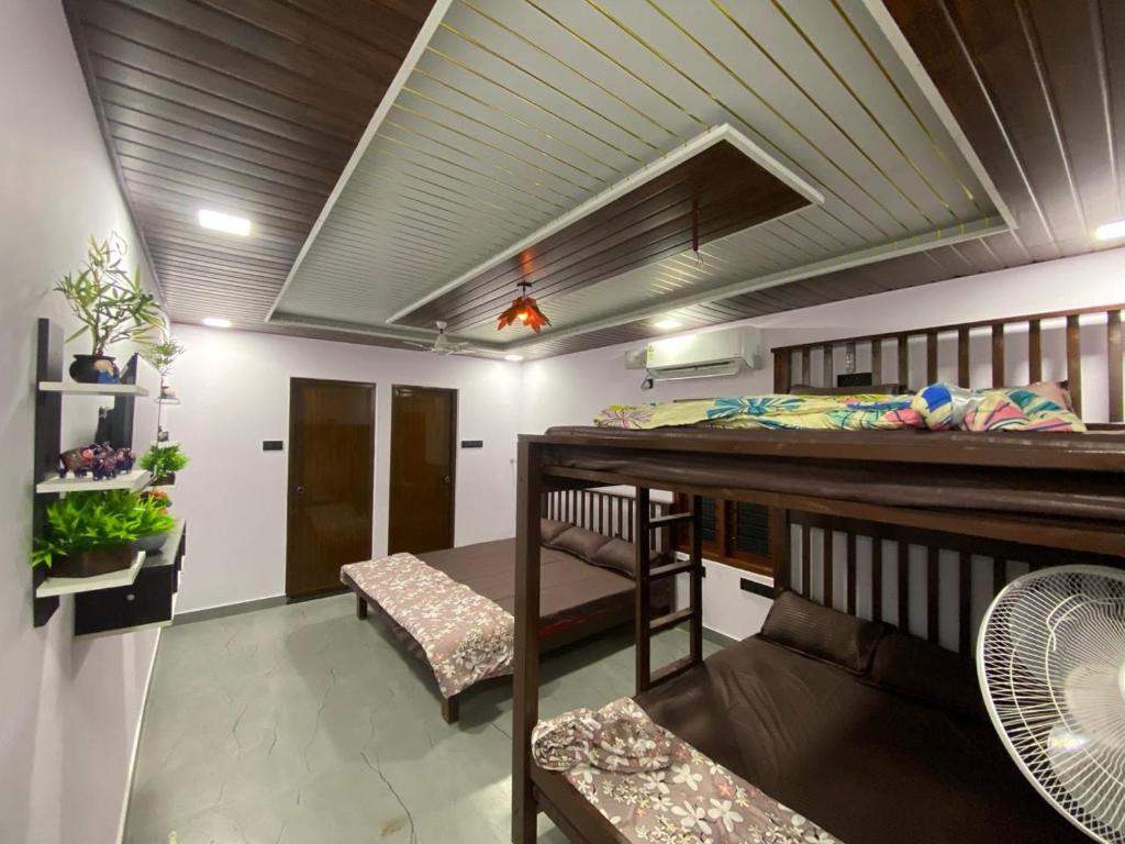 a room with a bunk bed and a desk at Rock n Ocean , Private Beach Stay in Udupi