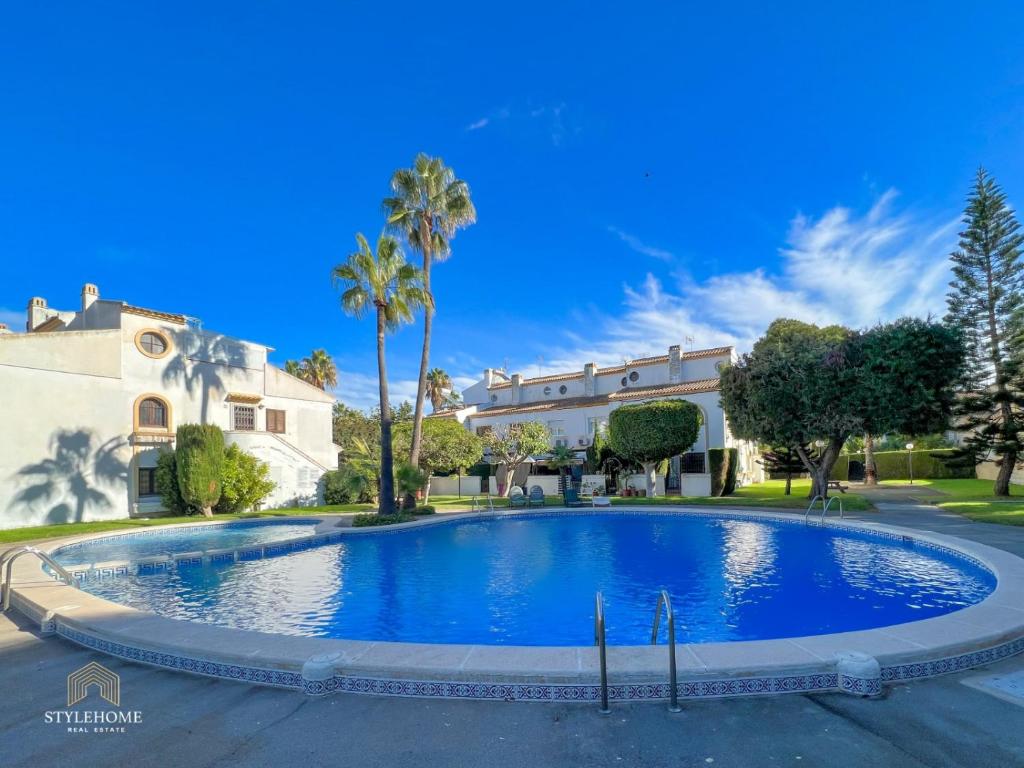 a large swimming pool in front of a house at Casa El Grande in Torrevieja