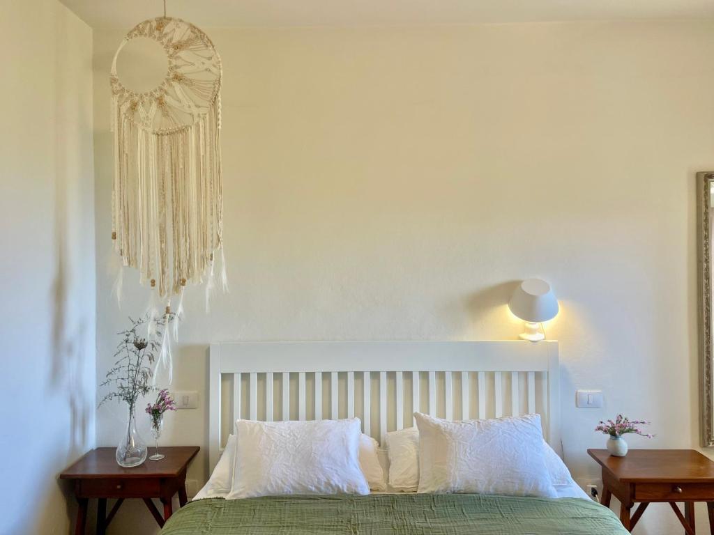 A bed or beds in a room at Aria di Collina - Isola d'Elba