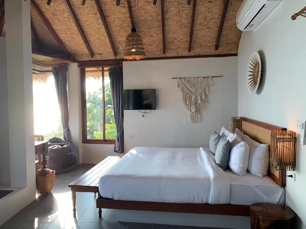 Postel nebo postele na pokoji v ubytování Kohtao Heritage Hideaway