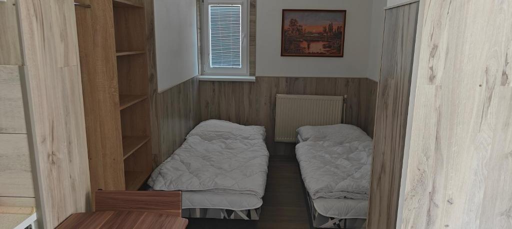 Habitación con 2 camas en una habitación con ventana en Apartmán 2 Hradná 9 en Nové Zámky
