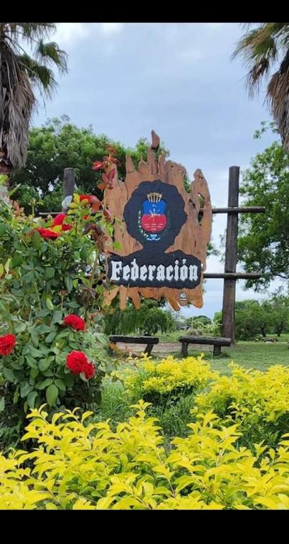 a sign for a disney garden with flowers at Departamento Mirasol in Federación