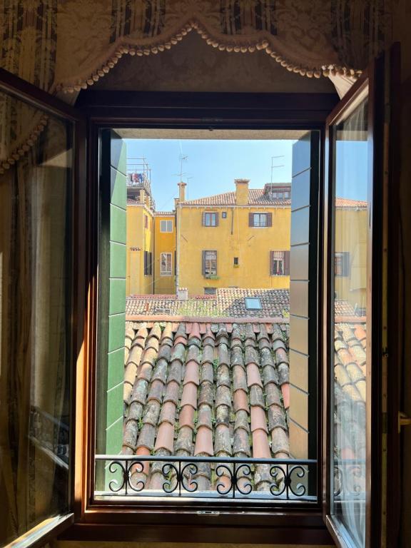 a window with a view of a building at Hotel Ca' Dogaressa in Venice