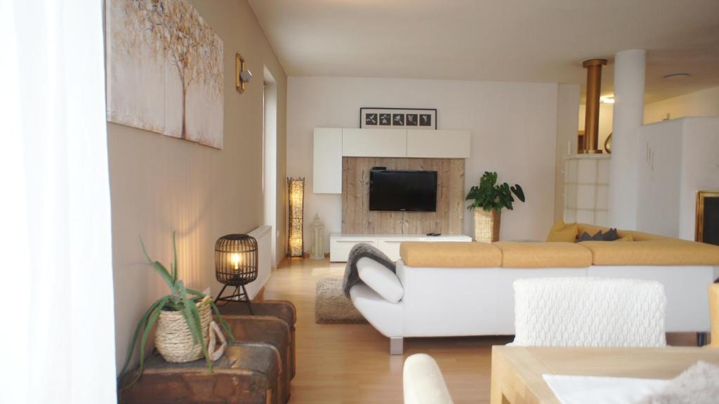 a living room with a couch and a bed at Apartment 66 in Bressanone