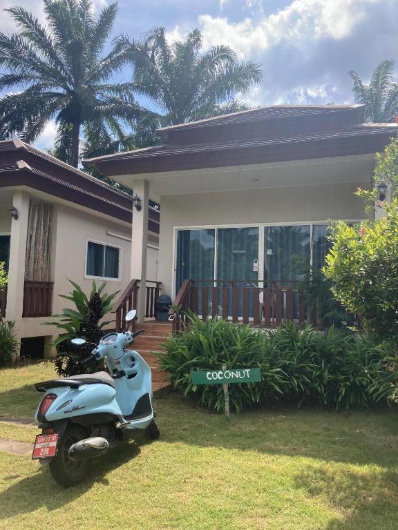 a scooter parked in front of a house at Lay Back Villa C2 with Kitchen & High speed Internet in Krabi