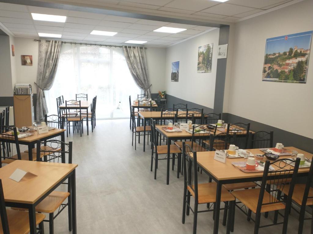 a dining room filled with tables and chairs at Résidence L&#39;Ogomé in Le Boupère