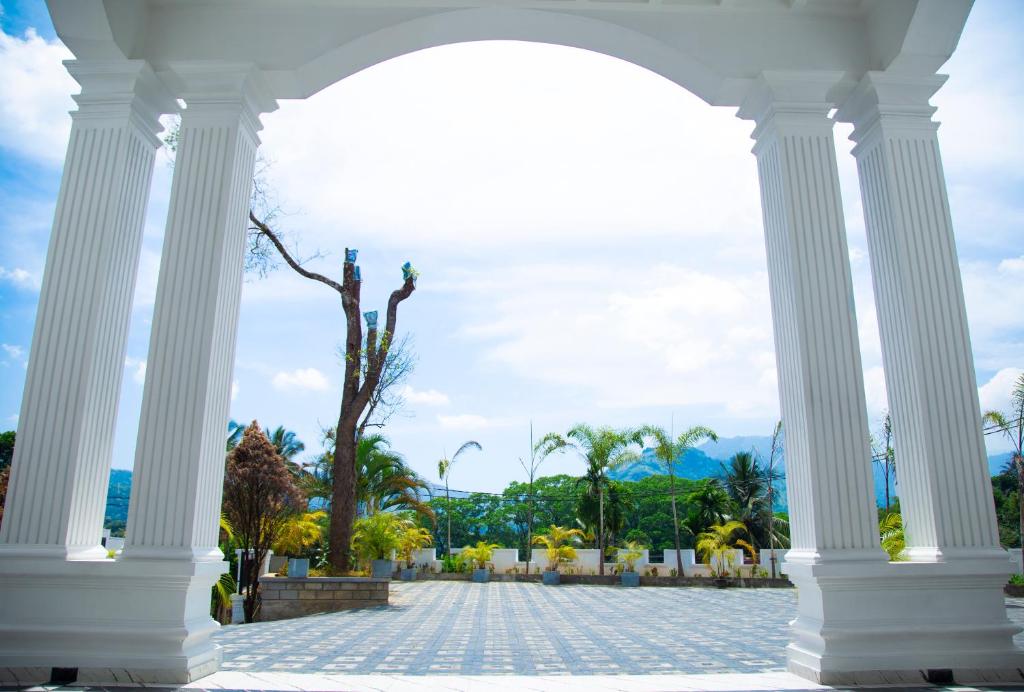 an archway with a palm tree in the background at CROWN REGENCY- BADULLA in Badulla