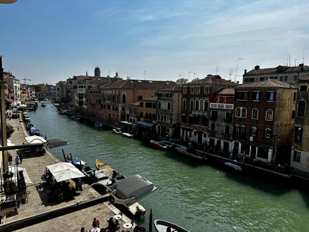 a view of a river with buildings and a city at Hotel Ca' Dogaressa in Venice
