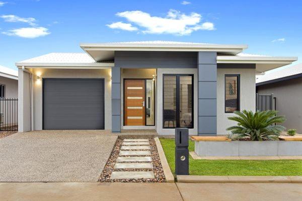 a small house with a garage in front of it at Private Room in Palmerston in Palmerston