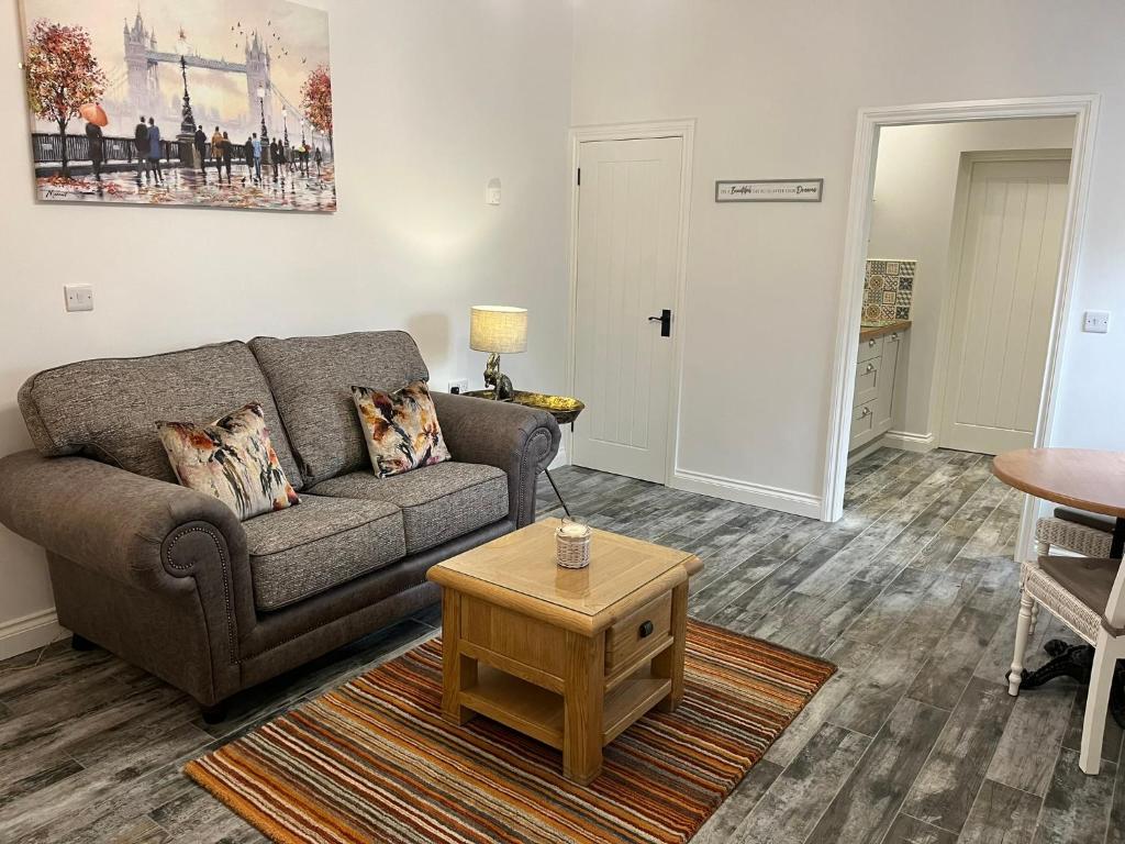 a living room with a couch and a coffee table at Millbrae Lodges in Belfast