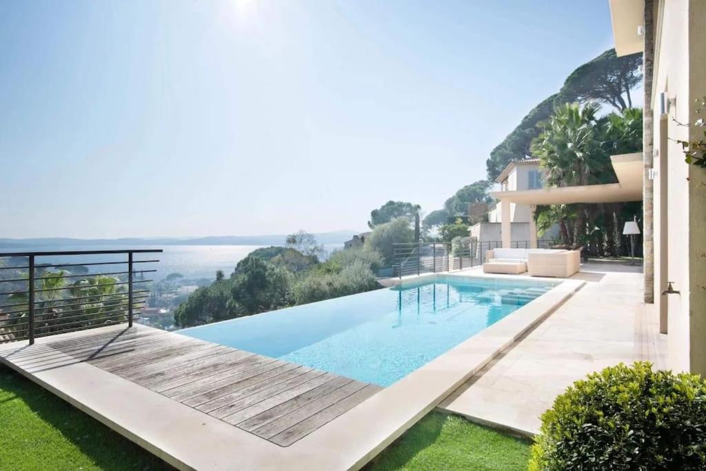 a swimming pool with a view of the ocean at Villa Sémaphore centre Sainte Maxime in Sainte-Maxime