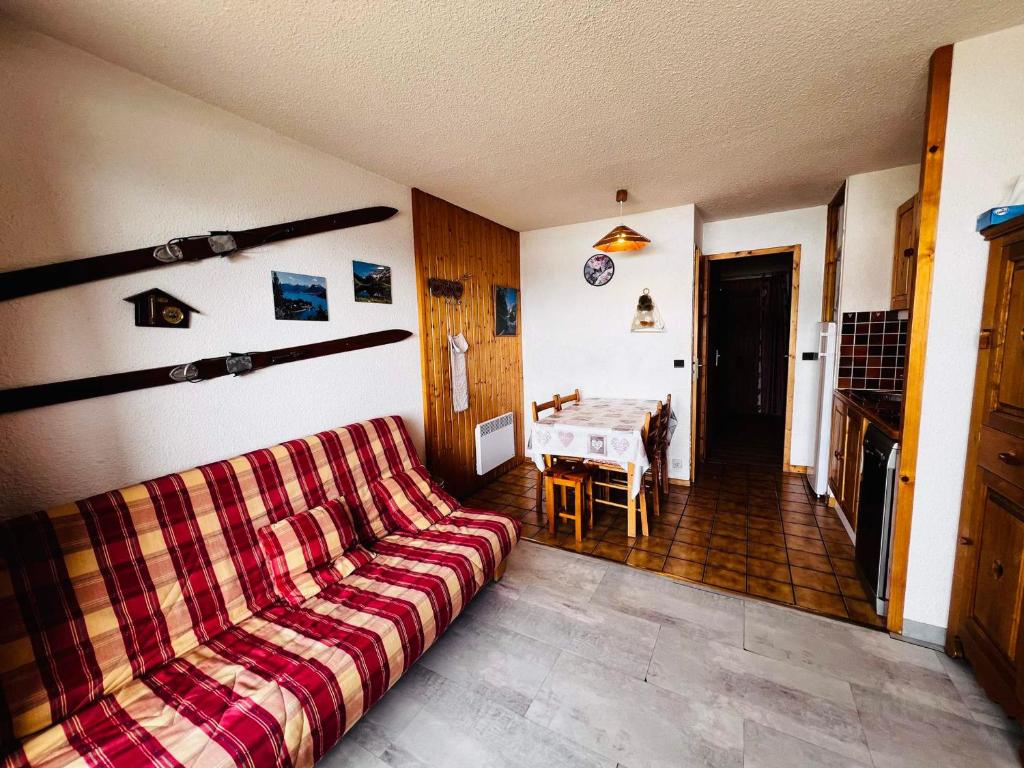 a living room with a couch and a table at Studio Les Saisies, 1 pièce, 4 personnes - FR-1-293-169 in Les Saisies