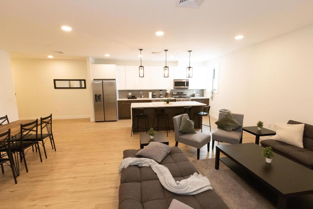 a living room and kitchen with a couch and a table at Stylish luxe apartment close to New york city in Union City