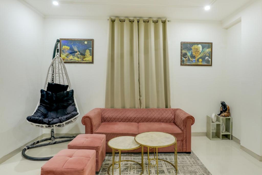 a living room with a couch and a swing at Premium 2bhk near Airport, Manipal Hospital, Venkatesh Hospital and Yashobhoomi Convention Centre in New Delhi