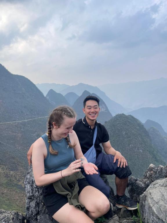 a man and a woman sitting on top of a mountain at LĨNH HƯƠNG RIVESIDE HOMESTAY in Làng Lap