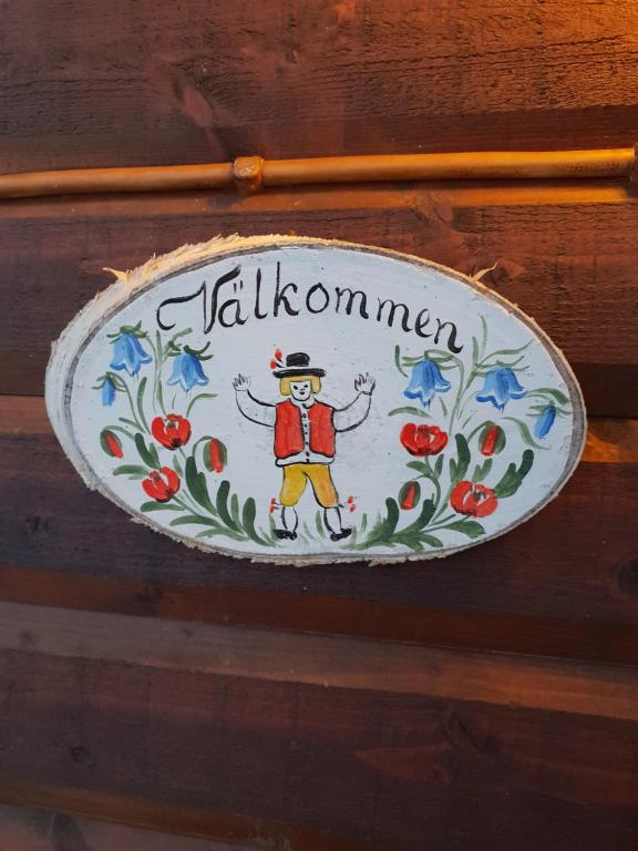 Ein Teller mit einem Mann mit Hut und Blumen. in der Unterkunft Tyforsgården in Mjölnartorpet
