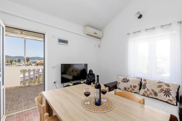 a living room with a table with wine glasses on it at Apartments Ivo Bozinovic in Tivat
