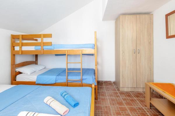 a bedroom with two bunk beds and a desk at Apartments Ivo Bozinovic in Tivat