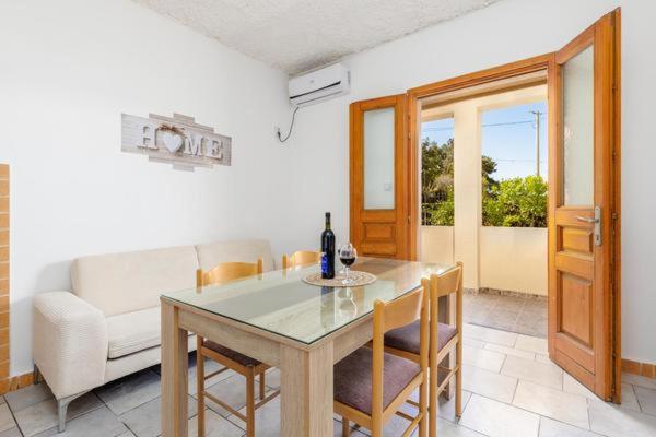a living room with a table and a couch at Apartments Ivo Bozinovic in Tivat