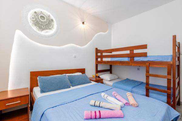 a bedroom with a bed with two bunk beds at Apartments Ivo Bozinovic in Tivat