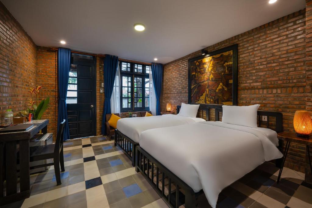 Postel nebo postele na pokoji v ubytování Calm House 3 Boutique hotel Hoi An