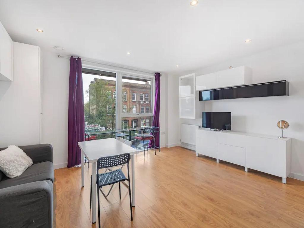 a living room with a couch and a table at Pass the Keys Spacious Apartment in Camberwell in London