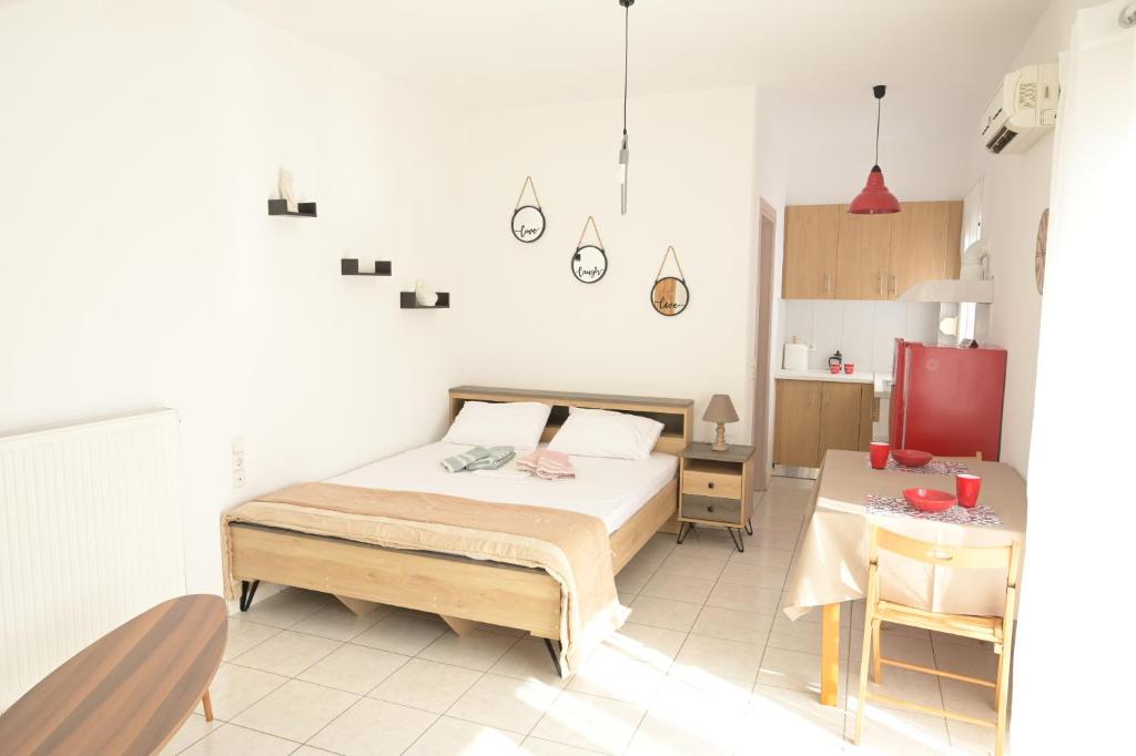 a bedroom with a bed and a table in it at Aurora Studio Apt for Couples & Friends in Heraklio Town