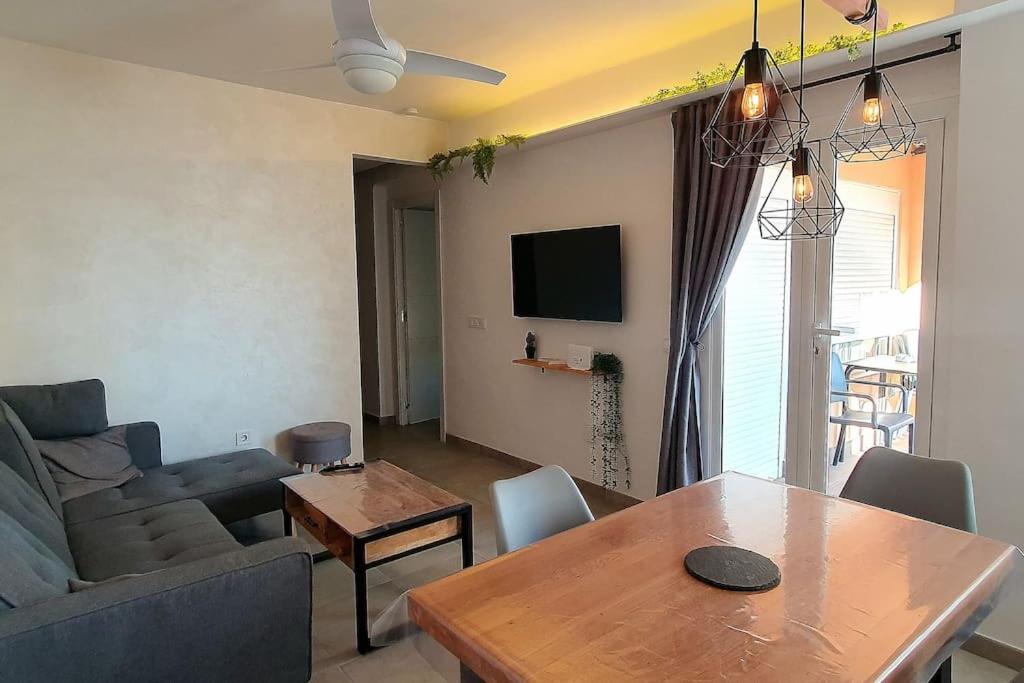 a living room with a couch and a table at SweetWater Beach - Apartamento turístico en zona puerto in Aguadulce