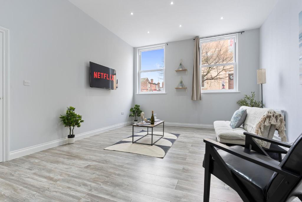 a living room with a couch and a table at Harwich Luxury Suite in Harwich