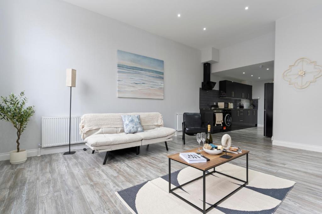 a living room with a couch and a table at Harwich Luxury Suite in Harwich