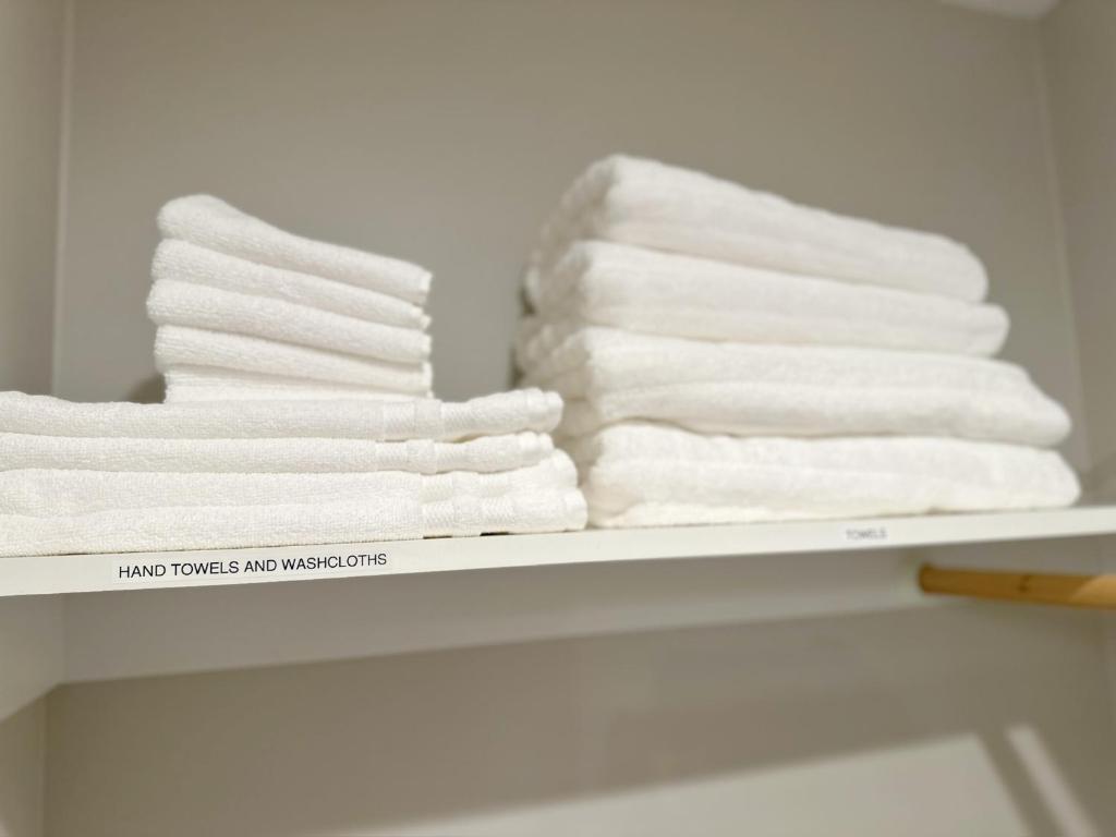 - une pile de serviettes sur une étagère dans une salle de bains dans l'établissement Bootlegger's Nest, à Anchorage