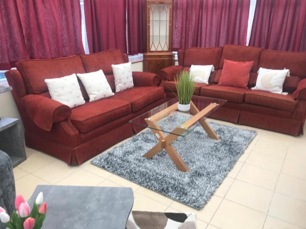 a living room with a couch and a coffee table at Modern Bromely House in BR5 in Foots Cray