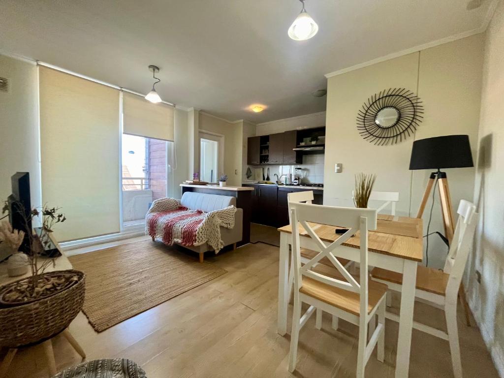 a kitchen and living room with a table and chairs at Departamento en Angol. in Angol