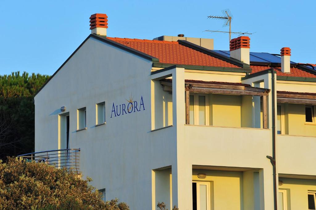 a building with a sign on the side of it at Hotel Aurora in San Vincenzo
