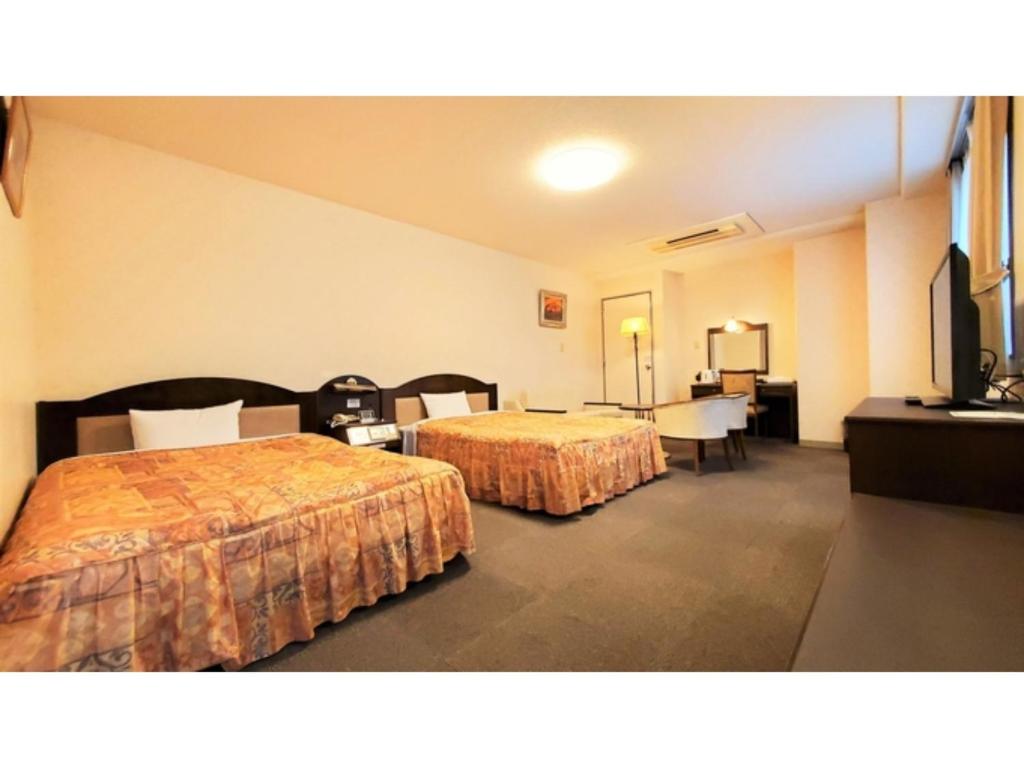 A bed or beds in a room at Nobeoka Urban-Hotel - Vacation STAY 30462v