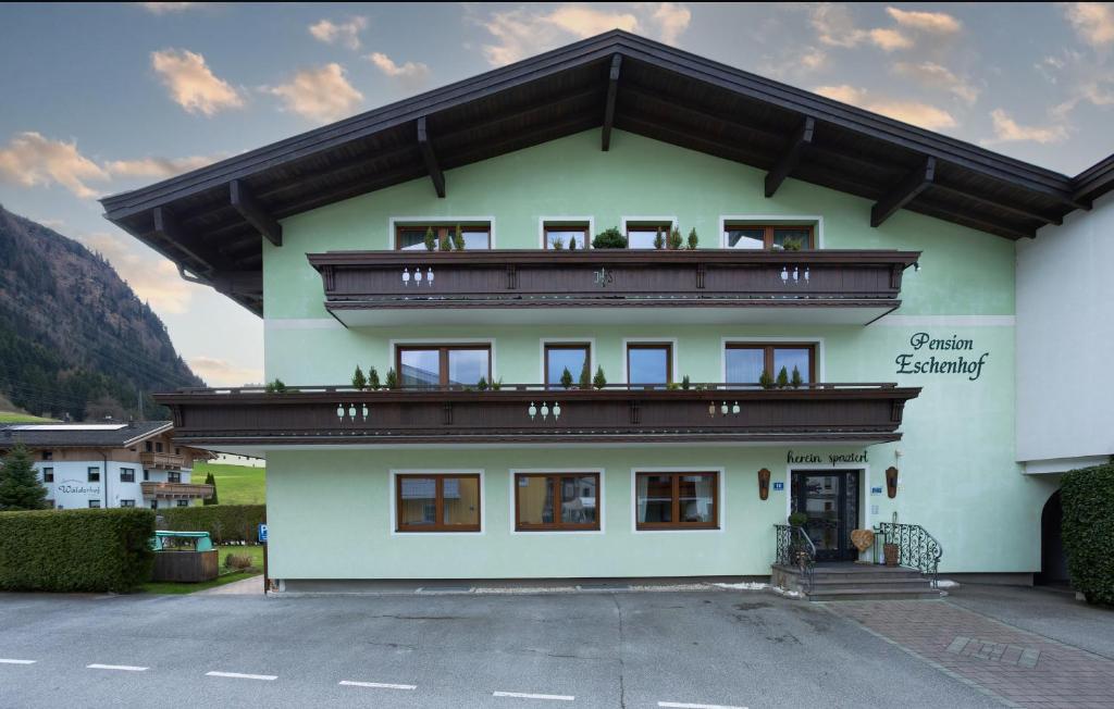 a building with a balcony on top of it at Pension Eschenhof in Kaprun